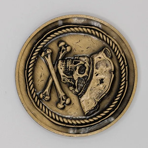 The reverse of the same coin: a pirate skull in a tricorn hat over crossed bones, inside a rope edge